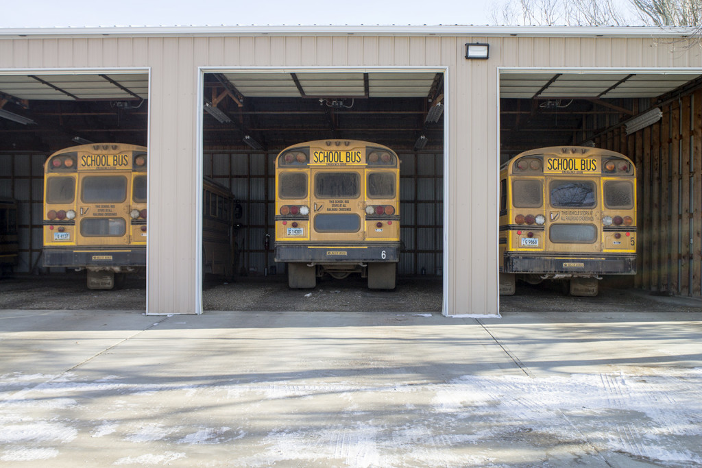 Bowman County owns its multiple school buses, parked in the school’s bus yard following a morning drive. (Photo by Bryce Martin/Pioneer)