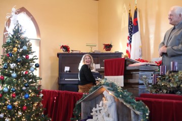 Cheryl Van Daele plays the piano and Terry Bagley performed the sermon at the annual Mound Christmas service. (Pioneer Photo by Jason Waskiewicz)