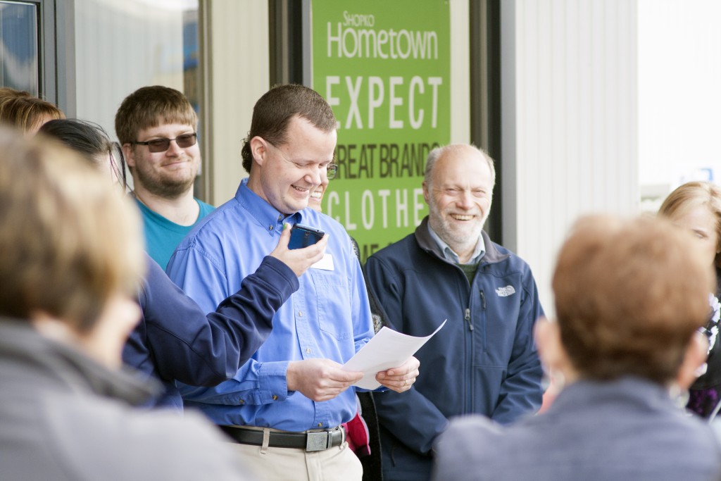 Scott Sola makes a big smile, which is echoed by the crowd, during his speech at the grand opening of Shopko. (Photo by Bryce Martin | Pioneer)