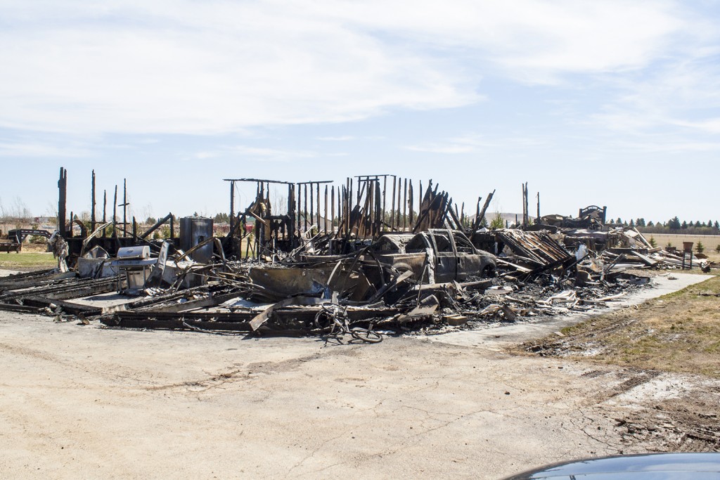 Flames quickly ripped through most of the home, including its attached garage, leaving nothing left but debris and a few salvageable possessions. (Photo by Bryce Martin | Pioneer)