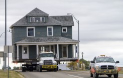 MOVING DAY: Passersby take notice as crews relocate large home