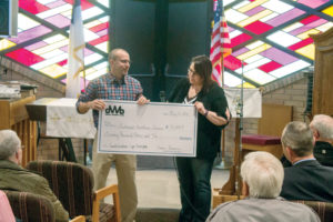 Duane Bowman of Dakota Western Bank presents the third installment—of $90,000—of its $350,000 pledge to Southwest Healthcare Services and the Sunrise Foundation during the May 10 "Topping Off" Ceremony. The sponsorship was set-up to be paid over a five-year period and is a contribution to fund SWHS’s campus expansion in Bowman. (Pioneer Photo by Bryce Martin)