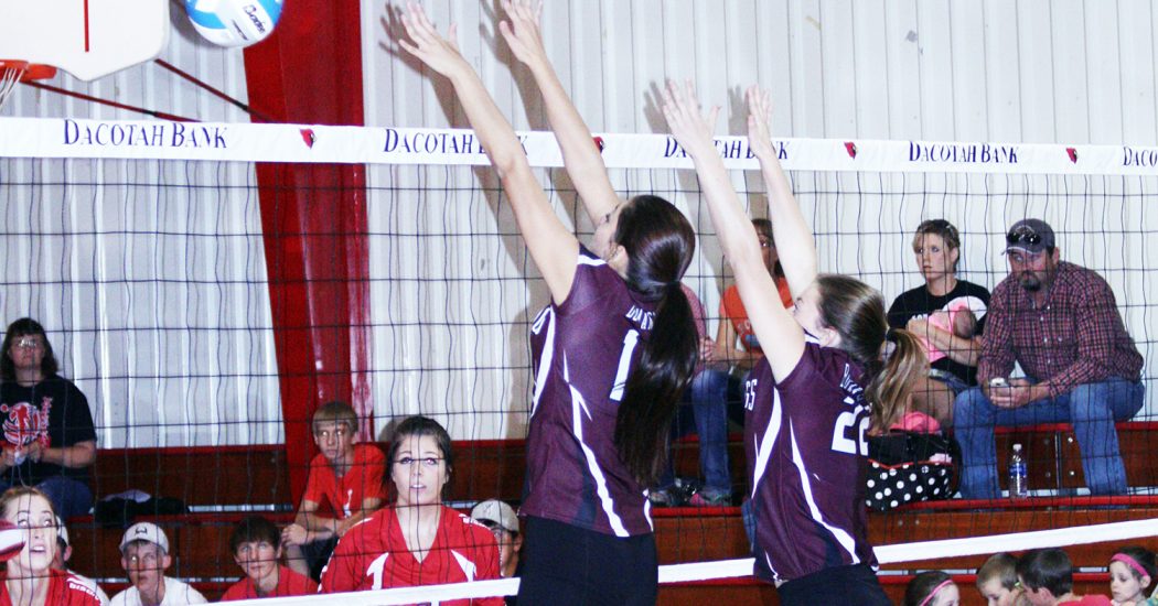 Kelsie Good Shield and Lindsey Narum block a Bison attack.