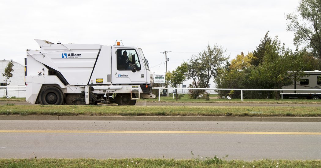 Todd Hofland, Bowman city street superintendent, operates the city’s street sweeper on a cloudy Wednesday afternoon, Sept. 21. (Pioneer Photo by Bryce Martin)
