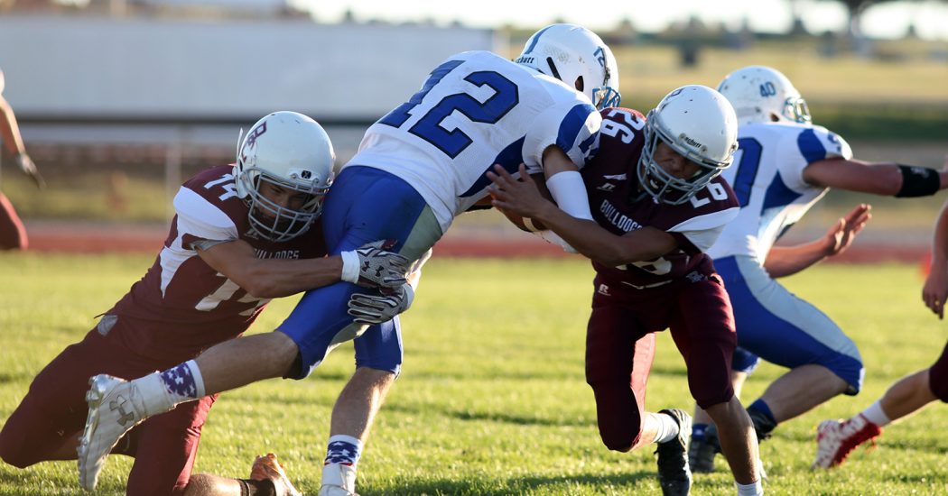 (Above) Brian Anaya (14) and Alex Madrigal (26) in on the tackle. (Pionner Photo by Jason Waskiewicz)