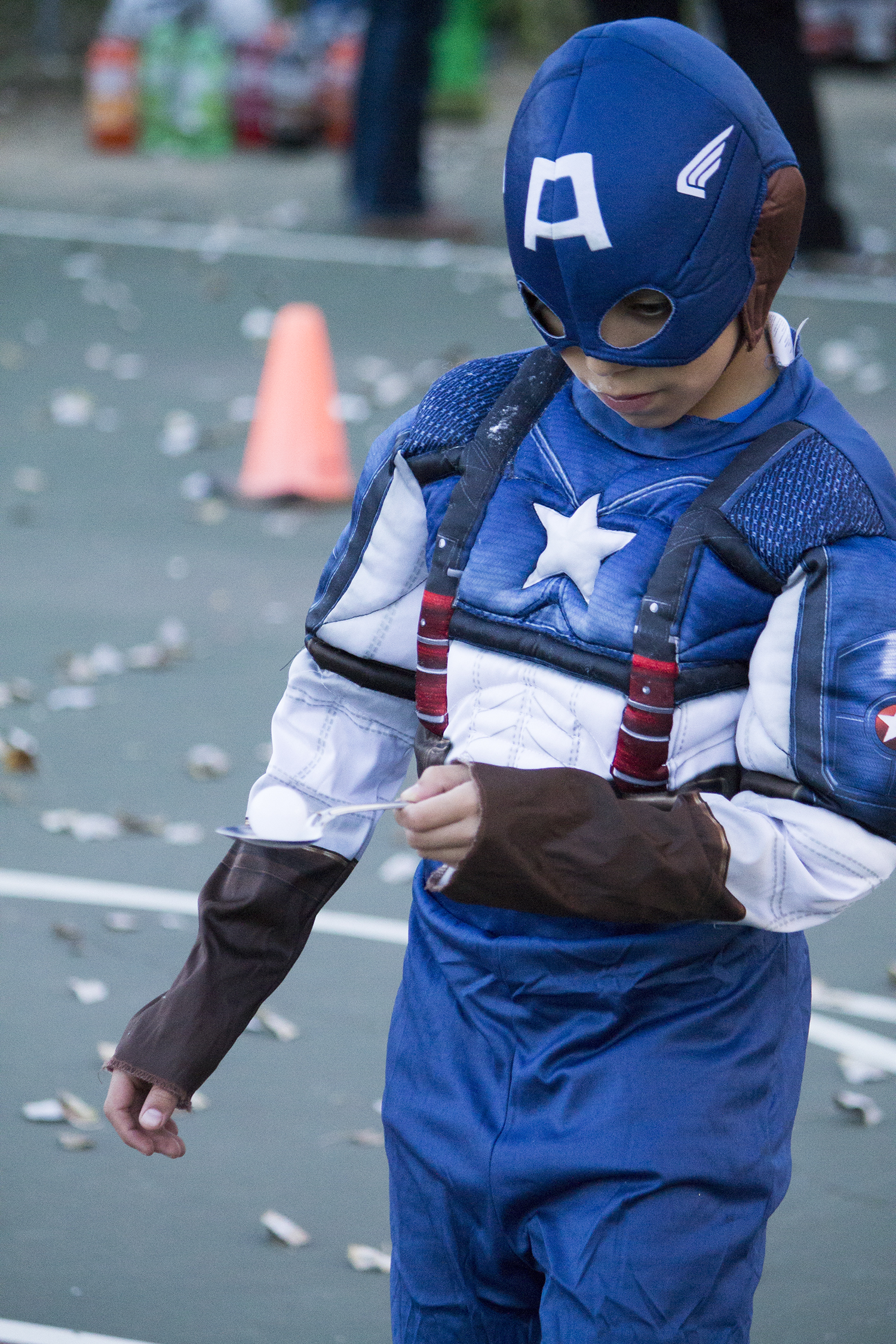 A boy dressed as Captain America tries not to drop an egg during one of the many games at last year’s FrightFest. (Pioneer Photo by Bryce Martin)